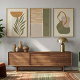 Modern living room with a green sofa, wooden sideboard, and abstract art on the wall.