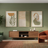 Modern living room with green walls, a wooden cabinet, and decorative items.