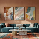 Modern living room with a teal sofa, abstract art, and decorative elements.