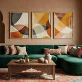 Green sectional sofa in a living room with abstract art and decor